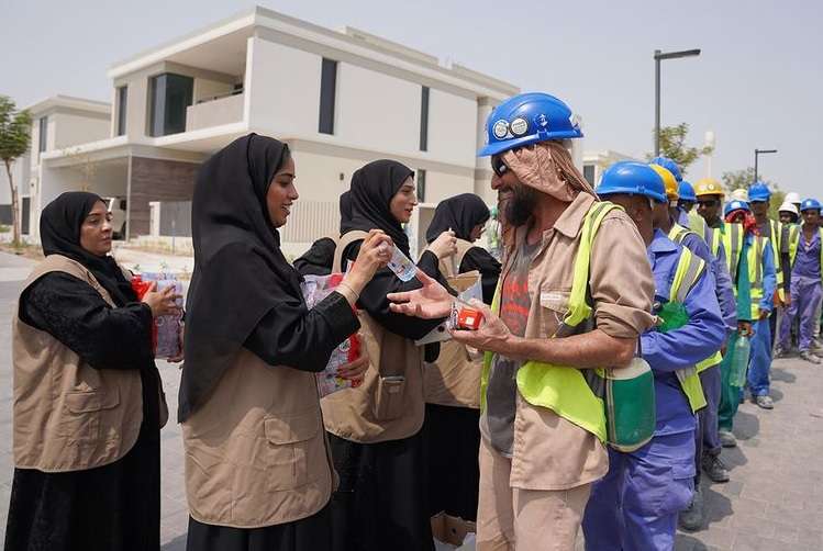 The construction workers were given cold drinks to cool off the heat
